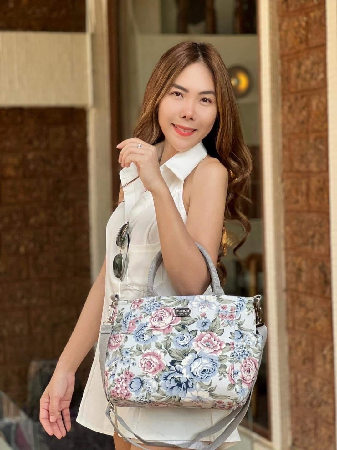 Woman holding Handmade Thailand Handbag in Cream Color Fabric with Pink and Blue Rose Pattern