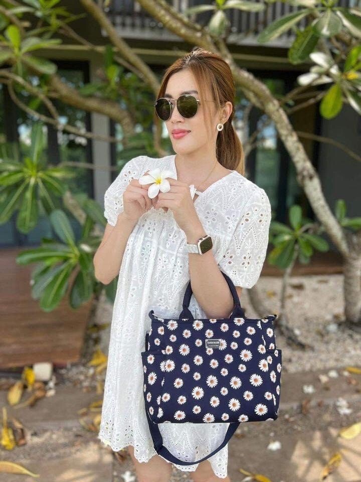 Woman holding Handmade Thailand Handbag in Dark Blue Fabric with White Daisy Pattern