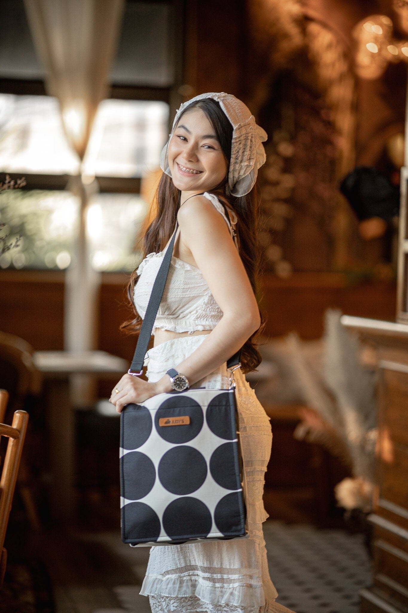 Thai girl with iPad Shoulder bag in large black circle on white pattern.