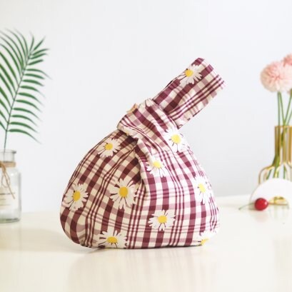 Japanese Knot Bag - Reversible and Compact Wrist Bag in a Daisy and Check pattern.