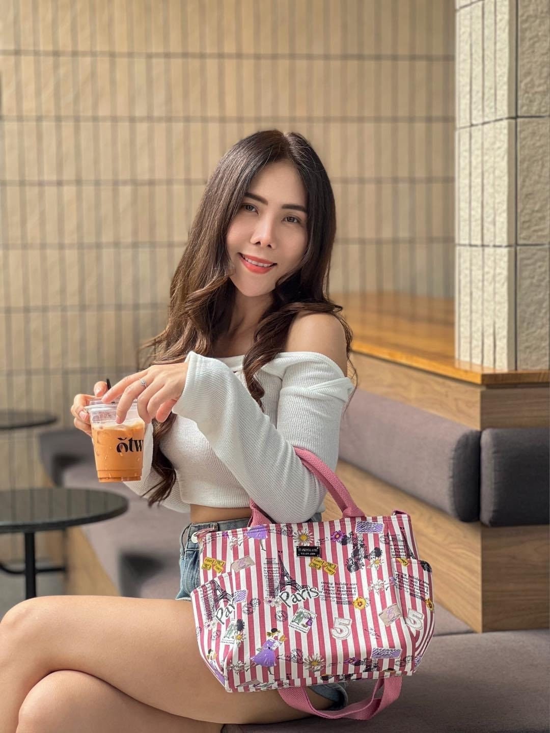 Girl sitting with Handmade Thailand Handbag in Pink and White stripe Fabric with Paris Eifel Tower and Perfume  Pattern