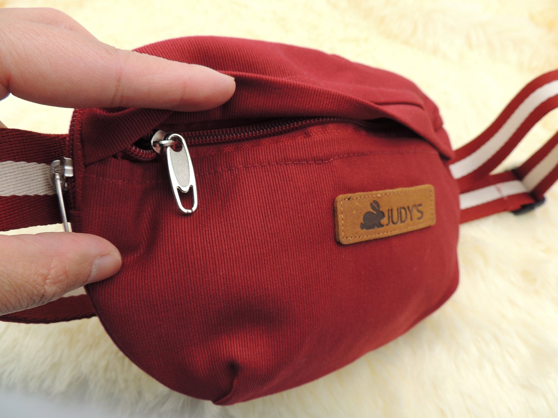 Small Handmade Crossbody Bag - Versatile in Maroon showing zipper on outside pocket