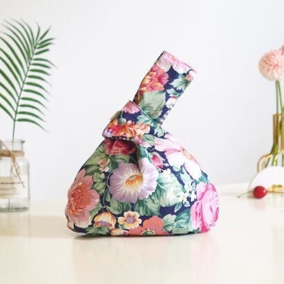 Japanese Knot Bag - Reversible and Compact Wrist Bag - Two Fabrics in One in a Floral Peonies pattern.